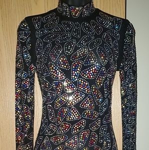 Beautiful dress covered in colored rhinestones .